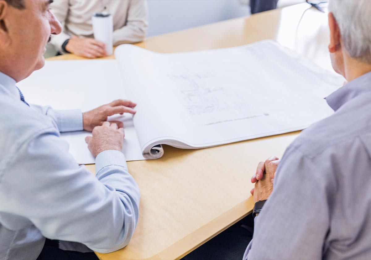 Image of buisnessmen looking at a blueprint